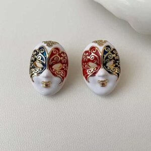 Artistic magical mask face earrings with red and blue enamel detailing and gold accents – statement jewelry from Glowfye